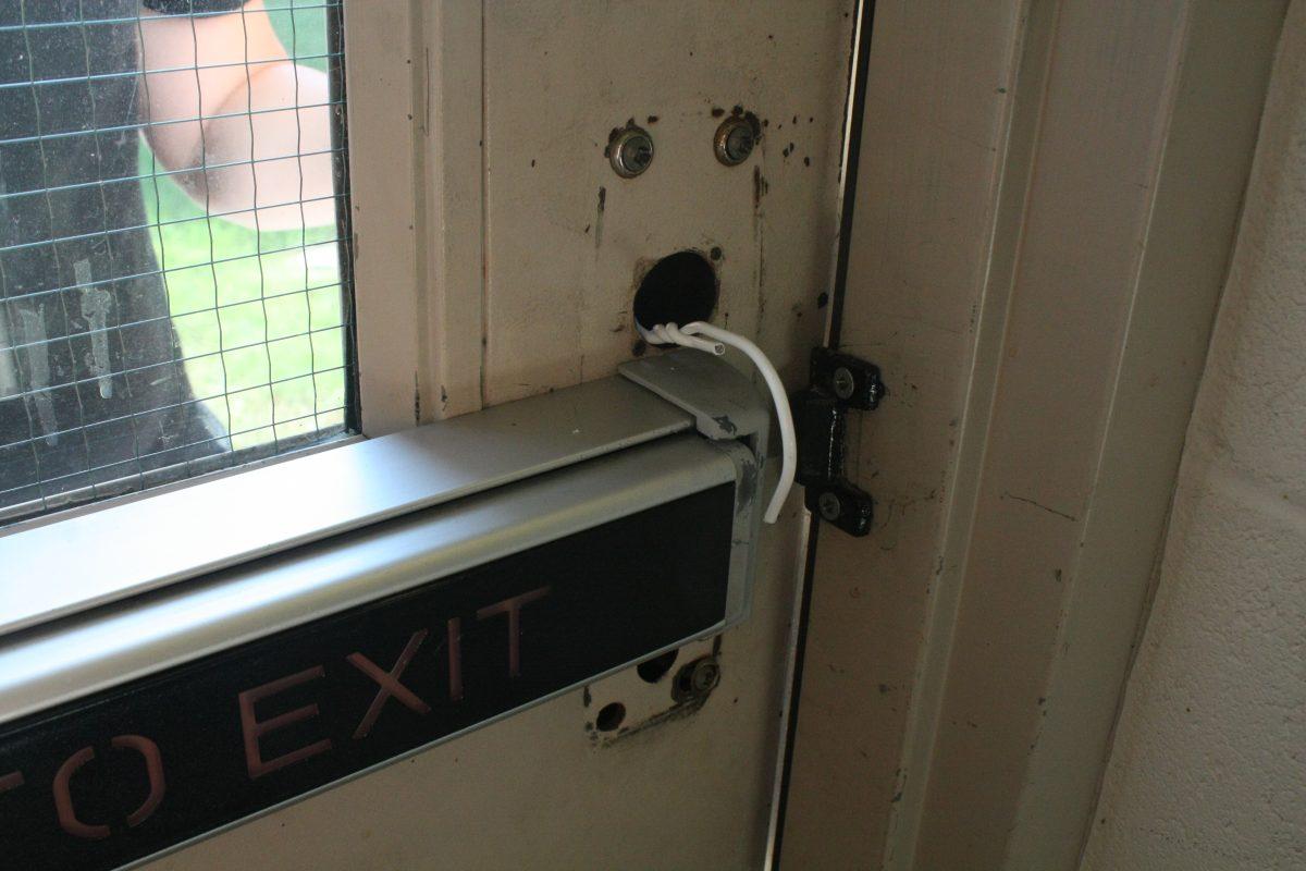 A wire hanger is used to gain access to the back left exterior door of New Hall without an escort or a swipe card. | PHOTO BY DANIEL BECKER