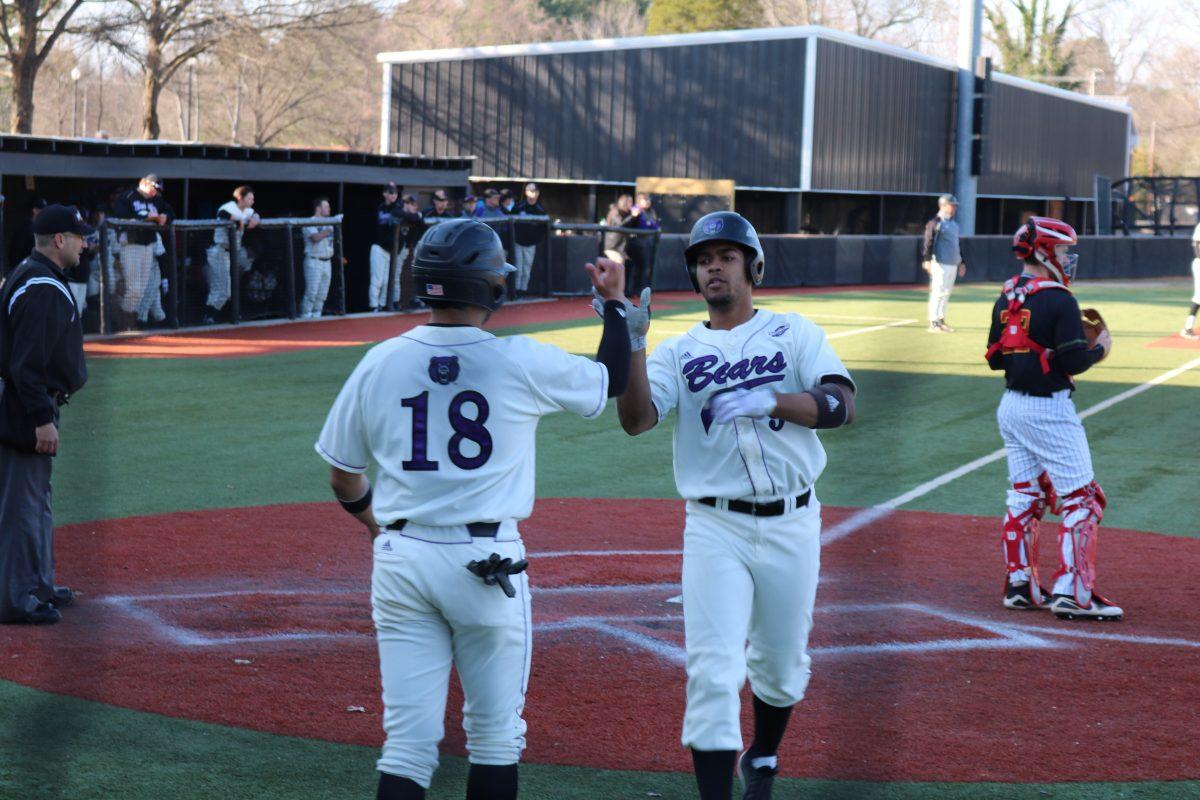 Junior outfielder Brett D’Amico greets senior infielder Josh Somdecerf with a high-five after Somdecerf runs home during the game against Mississippi Valley State March 7 at Bear Stadium. The Bears won 27-2 against the Delta Devils.