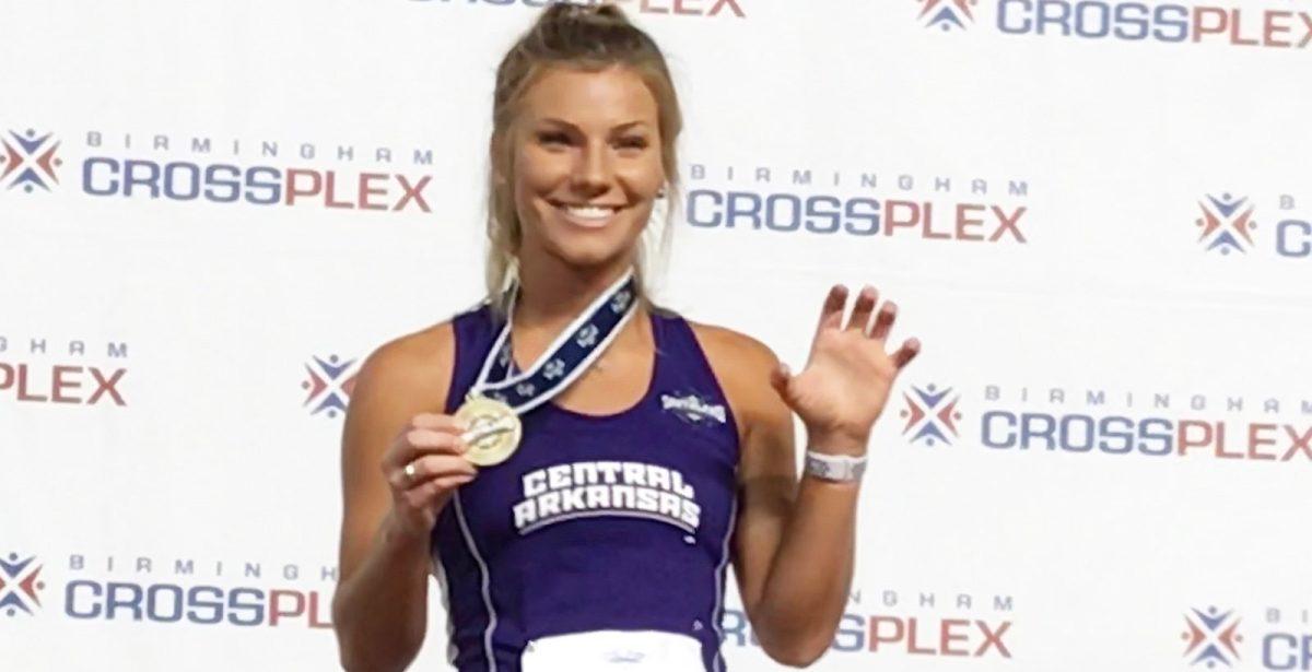 Junior Hannah Noble poses with a bear claw after placing first in the women’s high jump on Feb. 22 at the Indoor Track and Field Championships in Birmingham, Alabama.