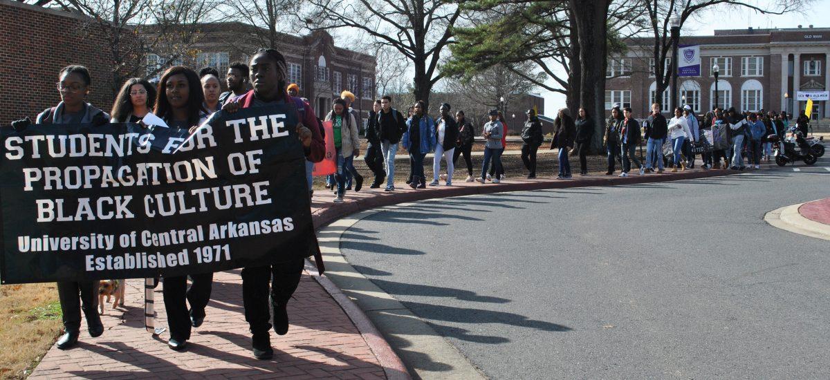 Junior Lashay Blackwell, Chaplain of SPBC, and senior Olivia Harvey, vice president of SPBC, lead the silent march during x-period Jan. 24. The annual march honored the life and legacy of Martin Luther King Jr.photo by Marley Cash-Powell 