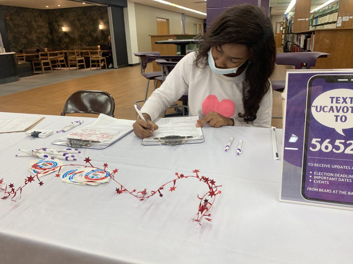 Freshman Denasia Hardin registers to vote at the booth hosted inside Torreyson Library. The booth was put on by Vote Everywhere and Invisible Little Rock and Central Arkansas. 