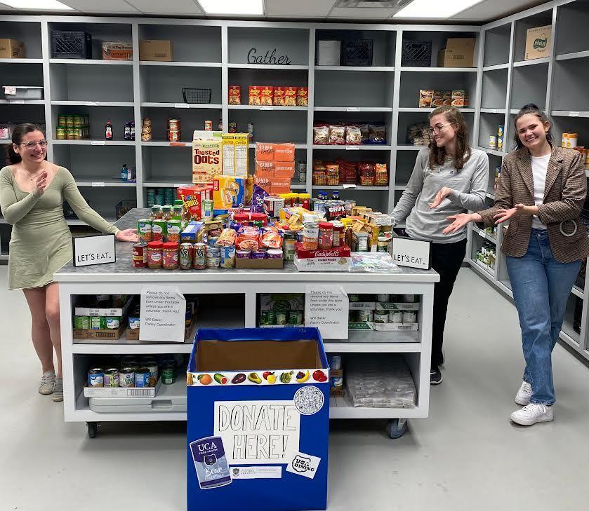 (from left to right) Wellness intern Kaitlyn Shae and dietetic interns Haley Donoway and Rose Rofkahr delivered donations to the Bear Essentials Food Pantry. The Stock the Den food drive gathered 228 lbs. of food in donations. 