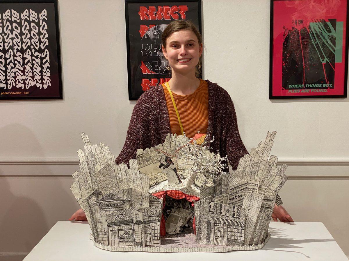 BFA student Mackenzie Drozd with “Accidents Happen” 2022. Altered book and mixed media.