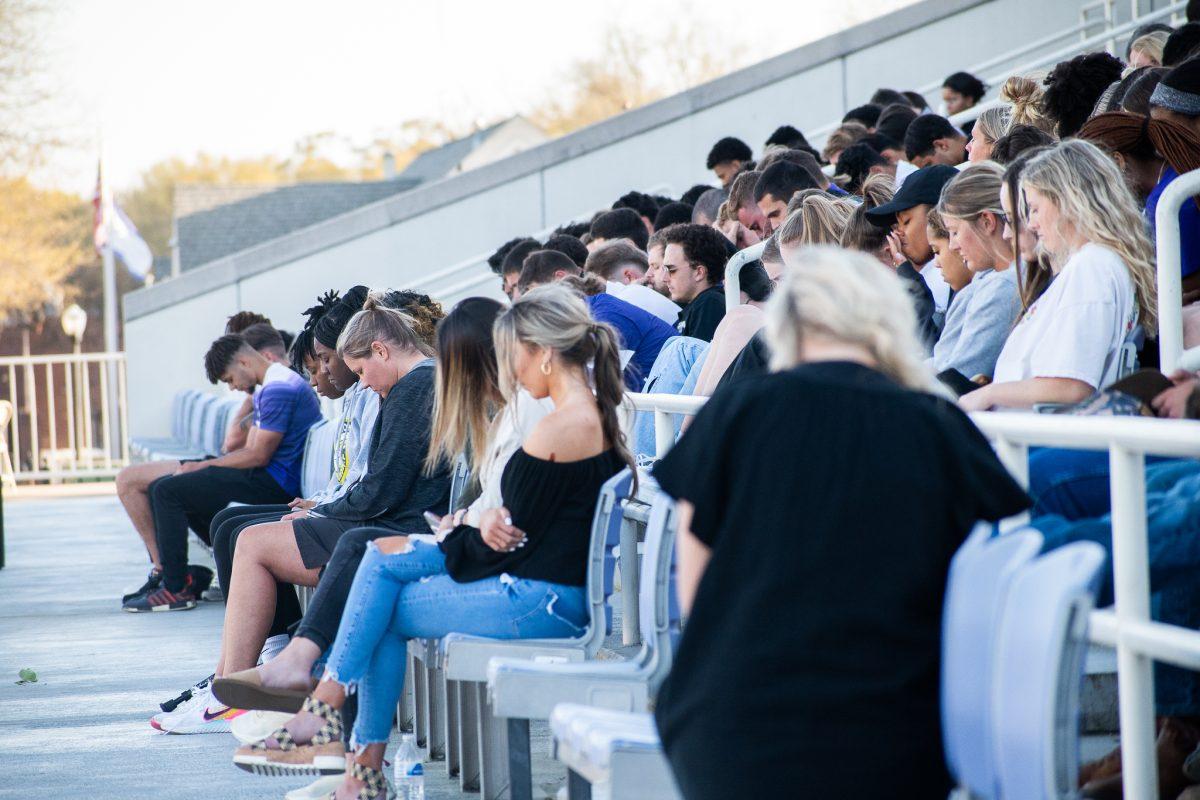 UCA students, football players, friends and family of Garrett Thomas bow their heads in remembrance. Coach Nathan Brown and best friend and teammate Austin Eldridge both spoke at the memorial. 