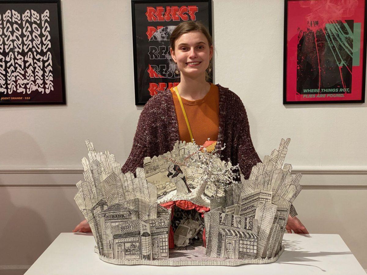 BFA student Mackenzie Drozd with “Accidents Happen” 2022. Altered book and mixed media.