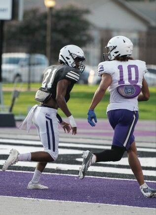 Number 21, freshman Travelle Anderson runs to block teammate Cole Brown.