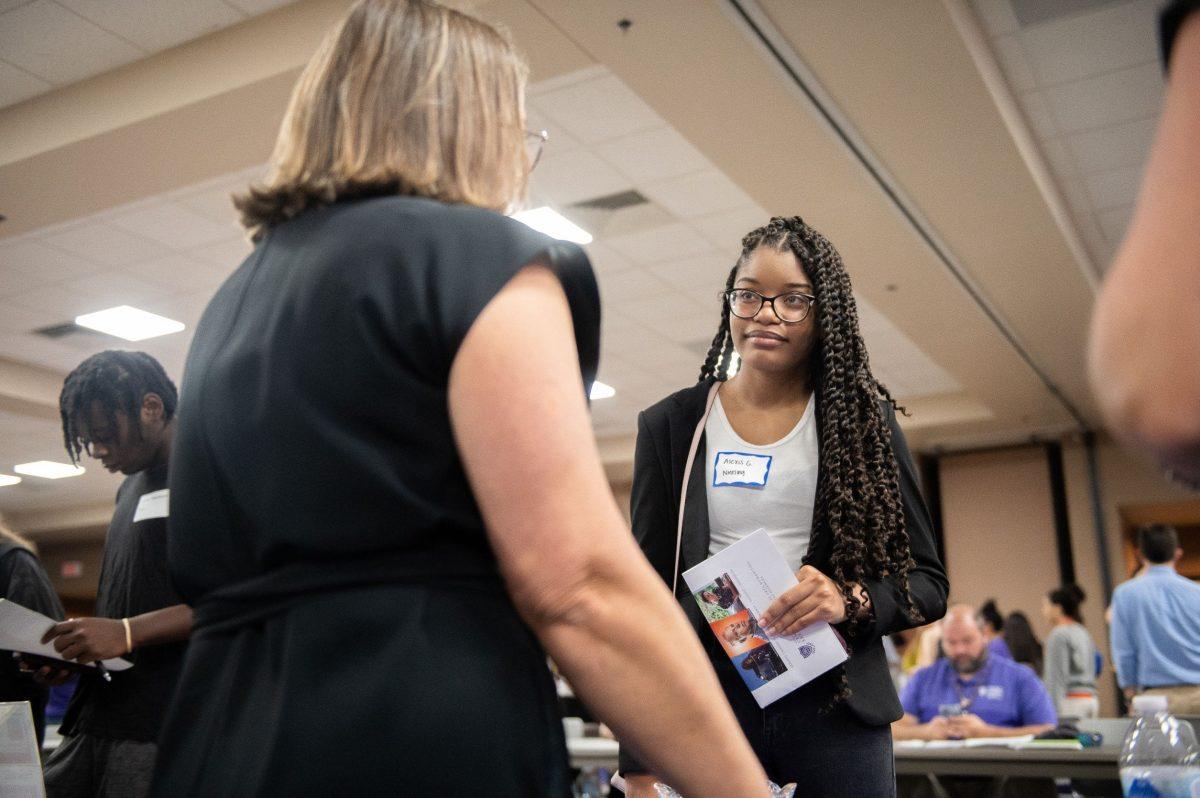 A student talks to a potential employer. 66 on-campus departments and organizations were featured at the student employment fair on Aug. 23.