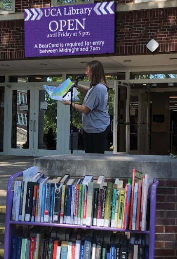 Freshman Olivia Smith reads “The Lorax” aloud outside the Torreyson Library Tuesday, Sept. 20. “The Lorax” made the list of banned books because of claims that it harms the logging industry.