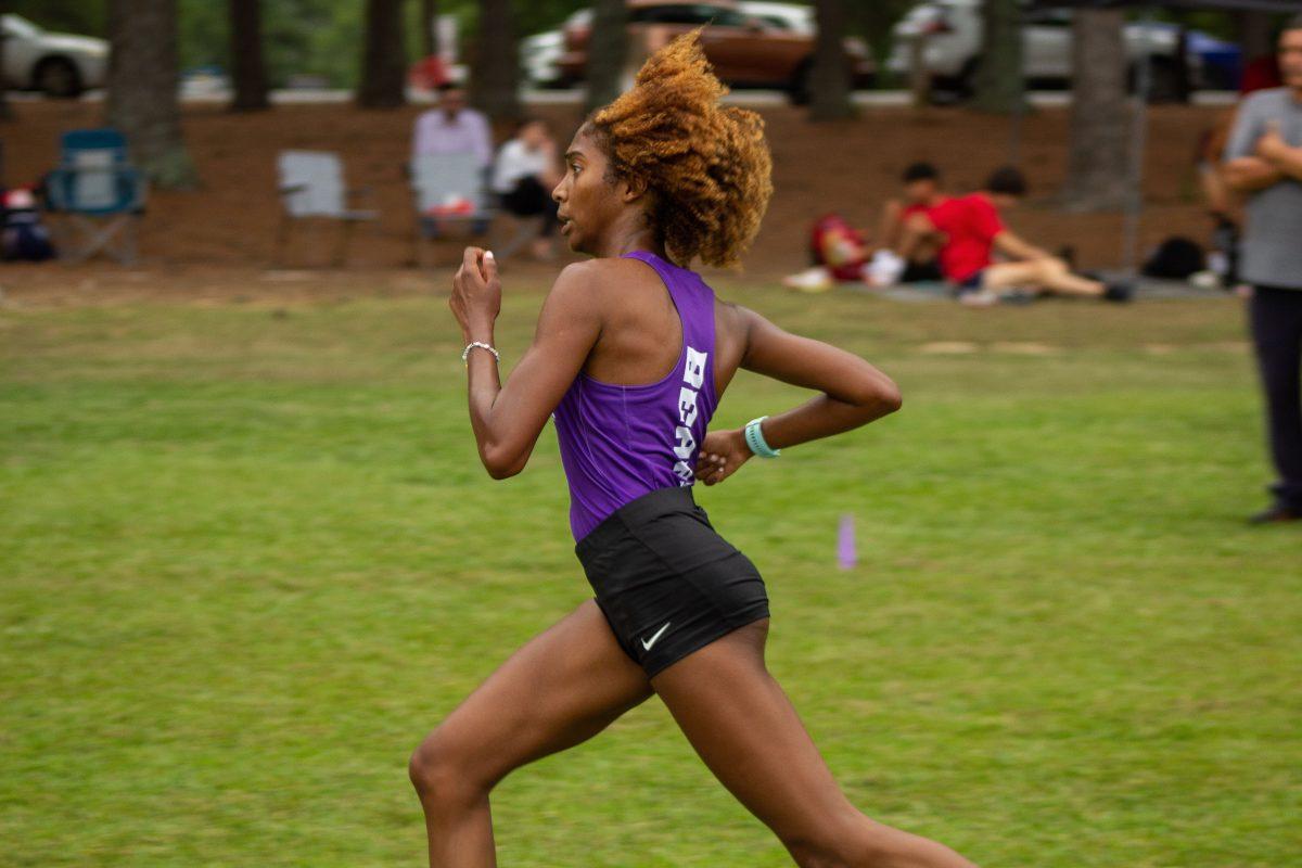 Freshman Zadie St. Louis sprints to the finish at the UCA Bear XC Invitational 5k Sept. 10. The women’s cross country team broke nine records at this meet.
