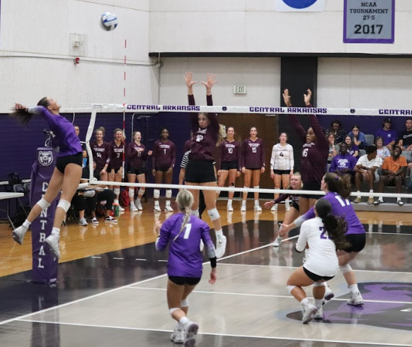 Sophomore Allison Holloway jumps to spike the ball in a matchup against Southern Illinois University, Sept. 9. This game was the first win following three straight losses in the Flo Hyman Collegiate Cup.