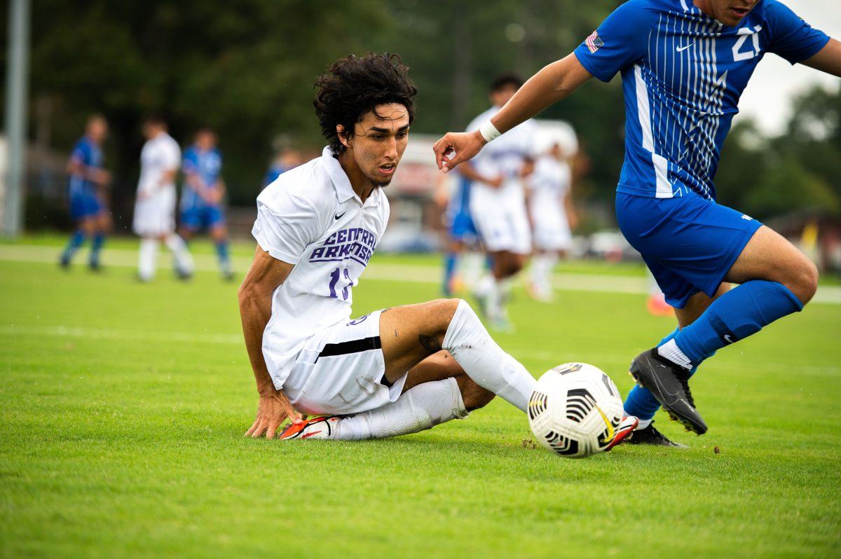 Junior defender Masood Porsa slides for the ball during the Bears’ game against the Air Force Academy Falcons Sept. 5. The Bears won the game 3-1, marking the first win of the season following a tie and two losses. The Bears next scored another win against North Florida University on Sept. 10 with a final score of 2-0.