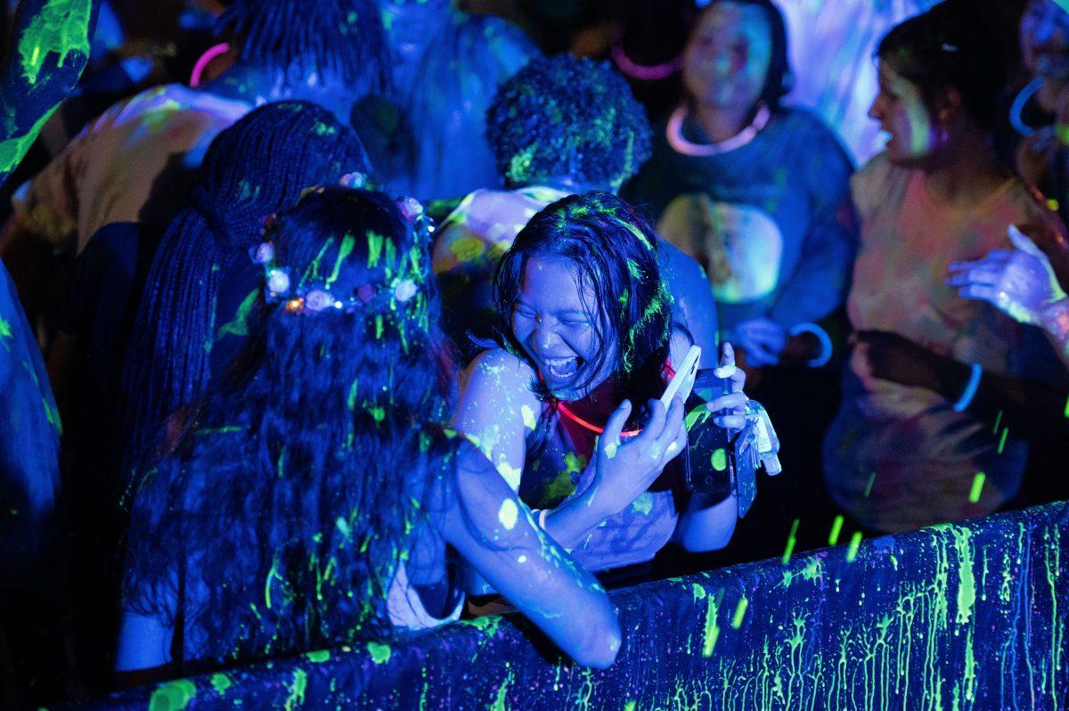 Students laugh as they’re sprayed with glow paint. Members of the Student Activities Board used water guns to spray paint at the crowd of partygoers at PaintU, which is described as the “largest collegiate paint party” by Degy Entertainment, a third-party company contracted by SAB.