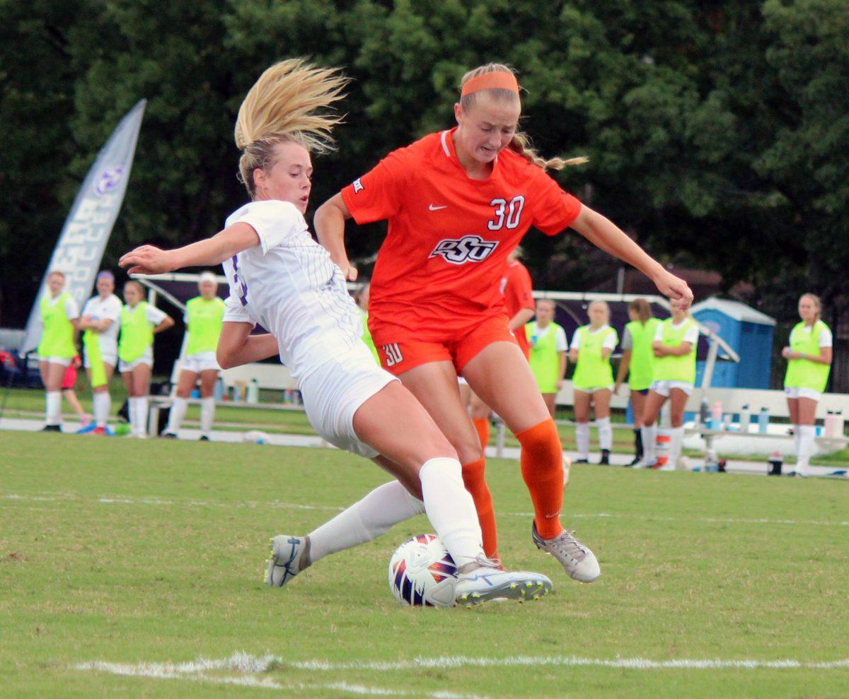 Freshman defender Rylee Ellis of UCA blocks the ball from senior midfielder Olyvia Dowell of Oklahoma State. The Bears lost to Oklahoma and later tied with Bellarmine.
