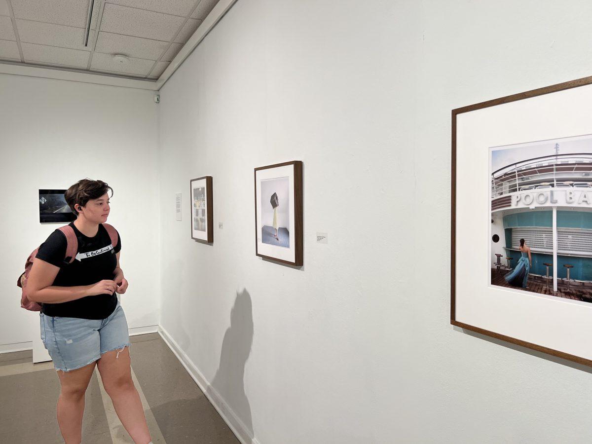 Junior Madi Robbins views Cig Harvey’s piece “The Hope Chest,” a self-portrait shot in Maine in 2007, in the Baum Gallery on Aug. 31. The exhibit is open until Oct. 13.