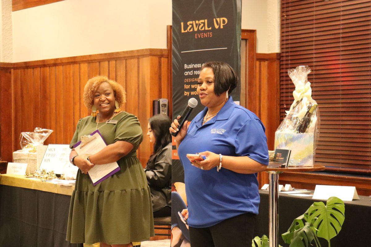 Shaniel Ealy (left) and Jamisa Hogan (right) speak to attendees at the Women’s Business Showcase. The event hosted 50 women-owned businesses from the central Arkansas area.