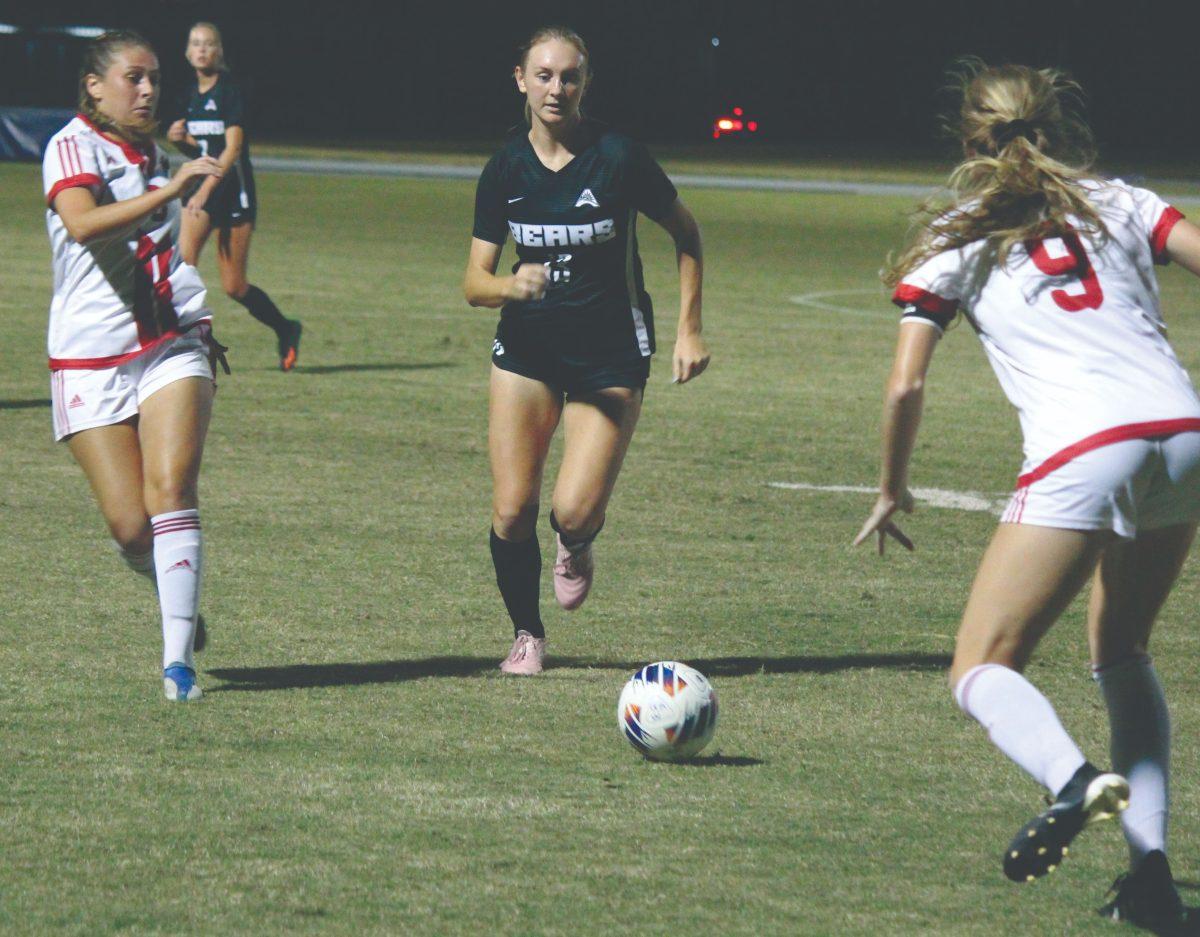 UCA graduate student defender Taylor Webb (center) pushes past senior gamecock defender Briana Eads (left). The theme of this home matchup was ‘Pups at the Pitch,’ which encouraged the audience to bring their dogs to the game.
