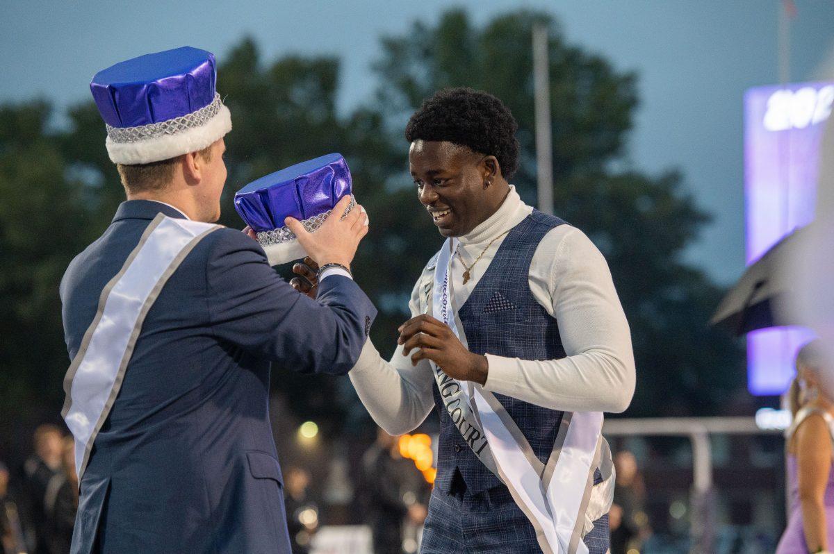 Homecoming King Tyler Cox (left) presents the crown to Homecoming King Nelson Omolo (right). The homecoming coronation was held at Estes Stadium during the football game’s halftime.