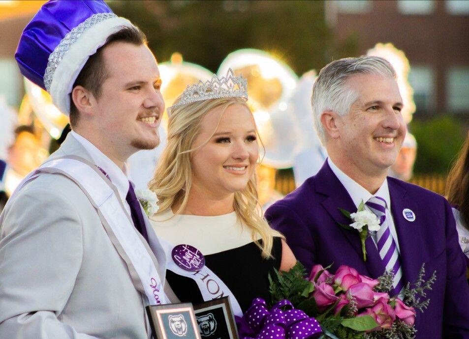 Homecoming King Tyler Cox (left), Homecoming Queen Savannah Jessup (middle) and President Houston Davis (right) smile at the Fall 2021 coronation.
