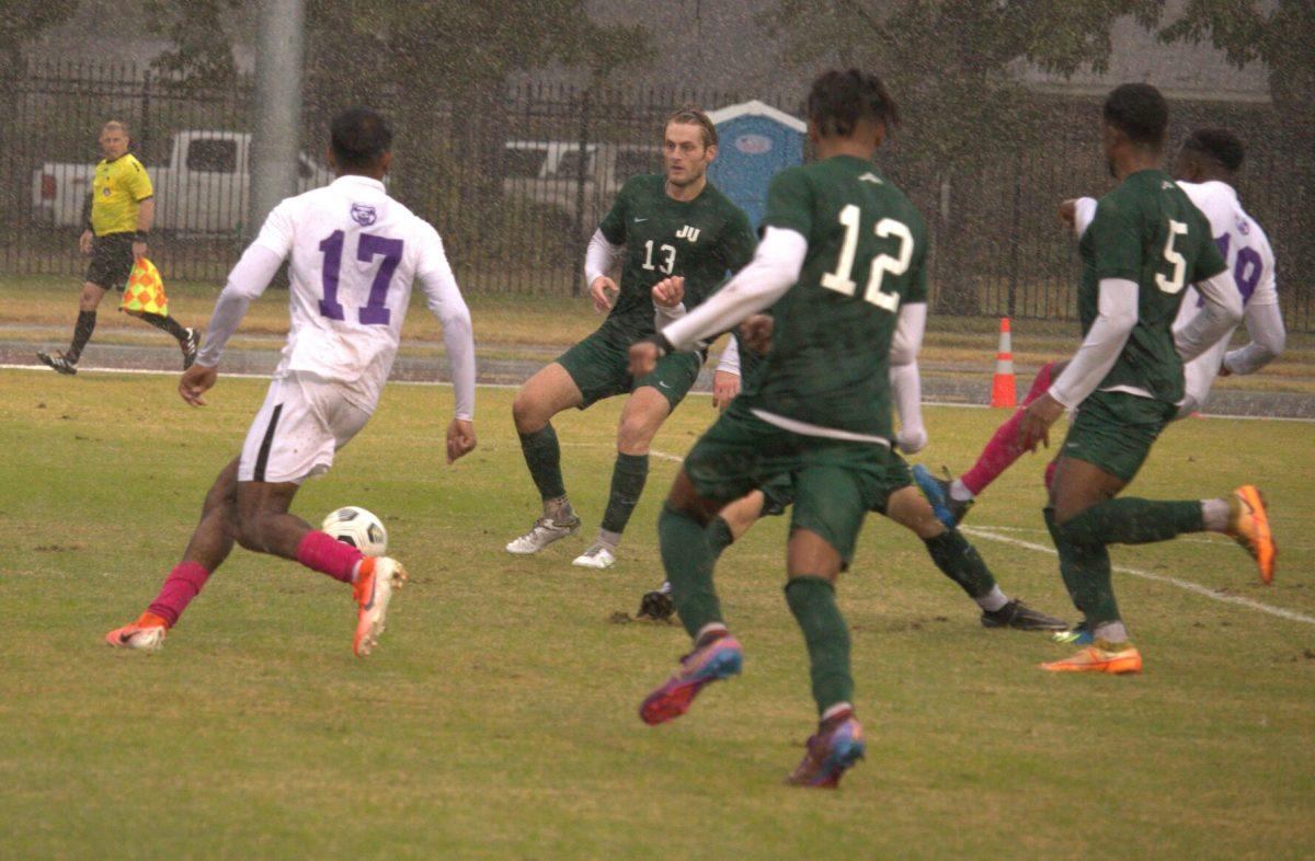 Sophomore Kris Naicker looks for an opening past Jacksonville University players. Though the Bears tied, the team claimed a spot in the ASUN
quarterfinals and will have at least one more home game Nov. 5.