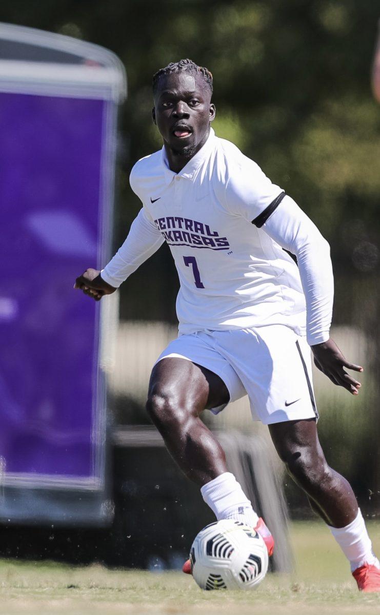 Karim Diao dribbles the ball down Bill Stephens field. Diao is a senior on the men’s soccer team and is originally from Bordeaux, France.
