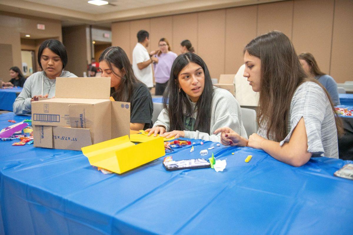 Members of the Latino Student Association decorate a Day of the Dead altar as part of an altar-creating competition. Teams worked together to build altars using paper, cardboard and clay. The winning team will be decided through Instagram likes and will be awarded $40.