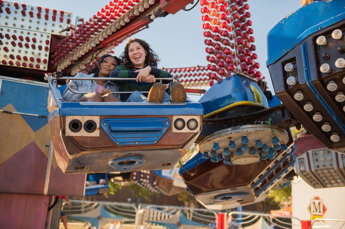 Attendees smile while on a ride at Fall Fest in the HPER parking lot Oct. 26. The event was held by the Student Activities Board.