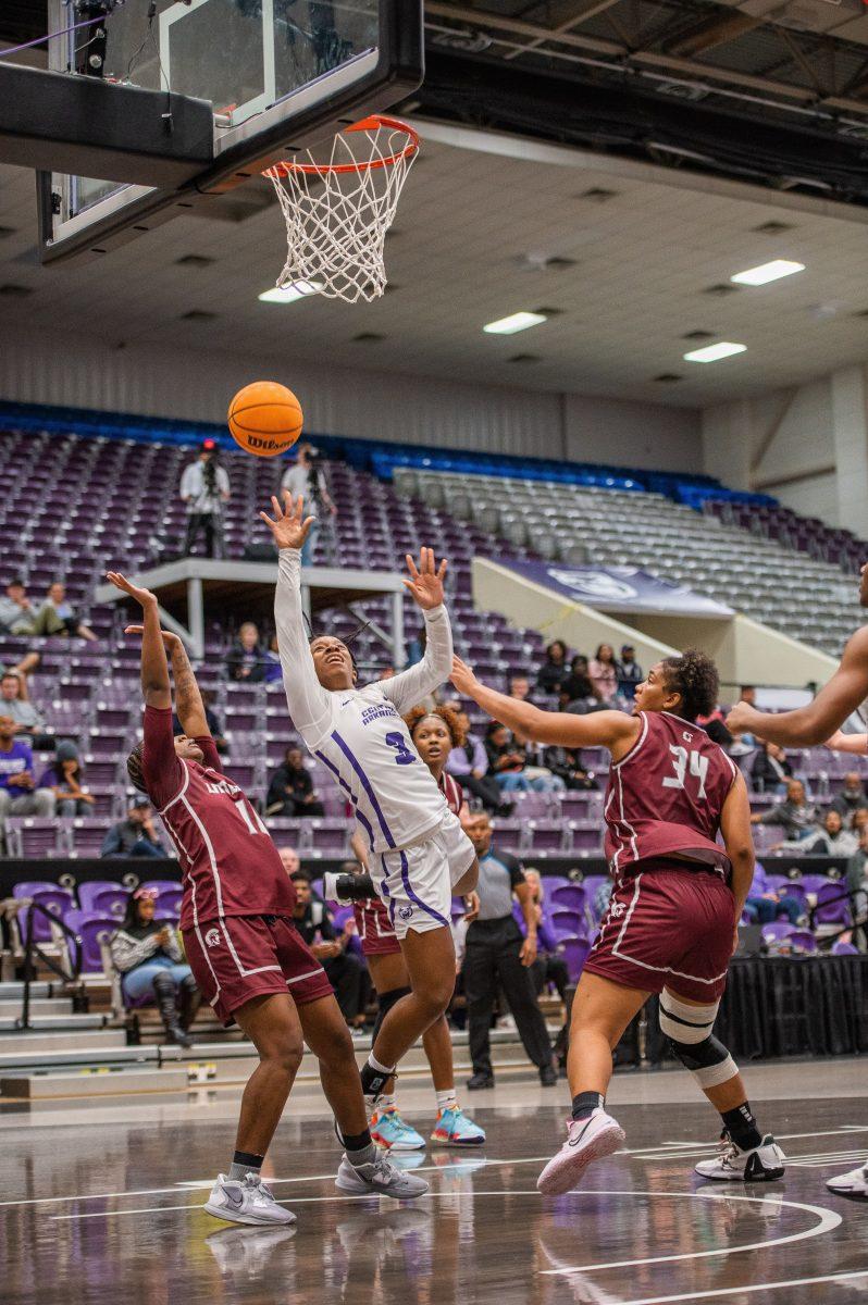 UCA sophomore guard Randrea Wright (middle) jumps for a basket ahead of UALR sophomore guard Jaiyah Harris-Smith (left) and UALR senior forward Angelique Francis.