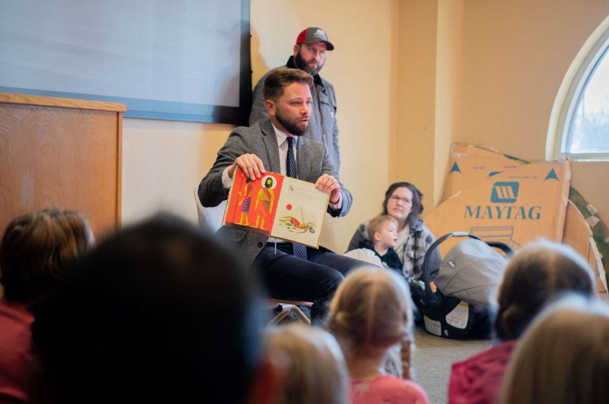 Owen Strachan, a member of Conway’s Grace Bible Theological Seminary, holds up the children's book "God's Design." Strachan himself is an author of books like "Christianity and Wokeness: How the Social Justice Movement Is Hijacking the Gospel - and the Way to Stop It."