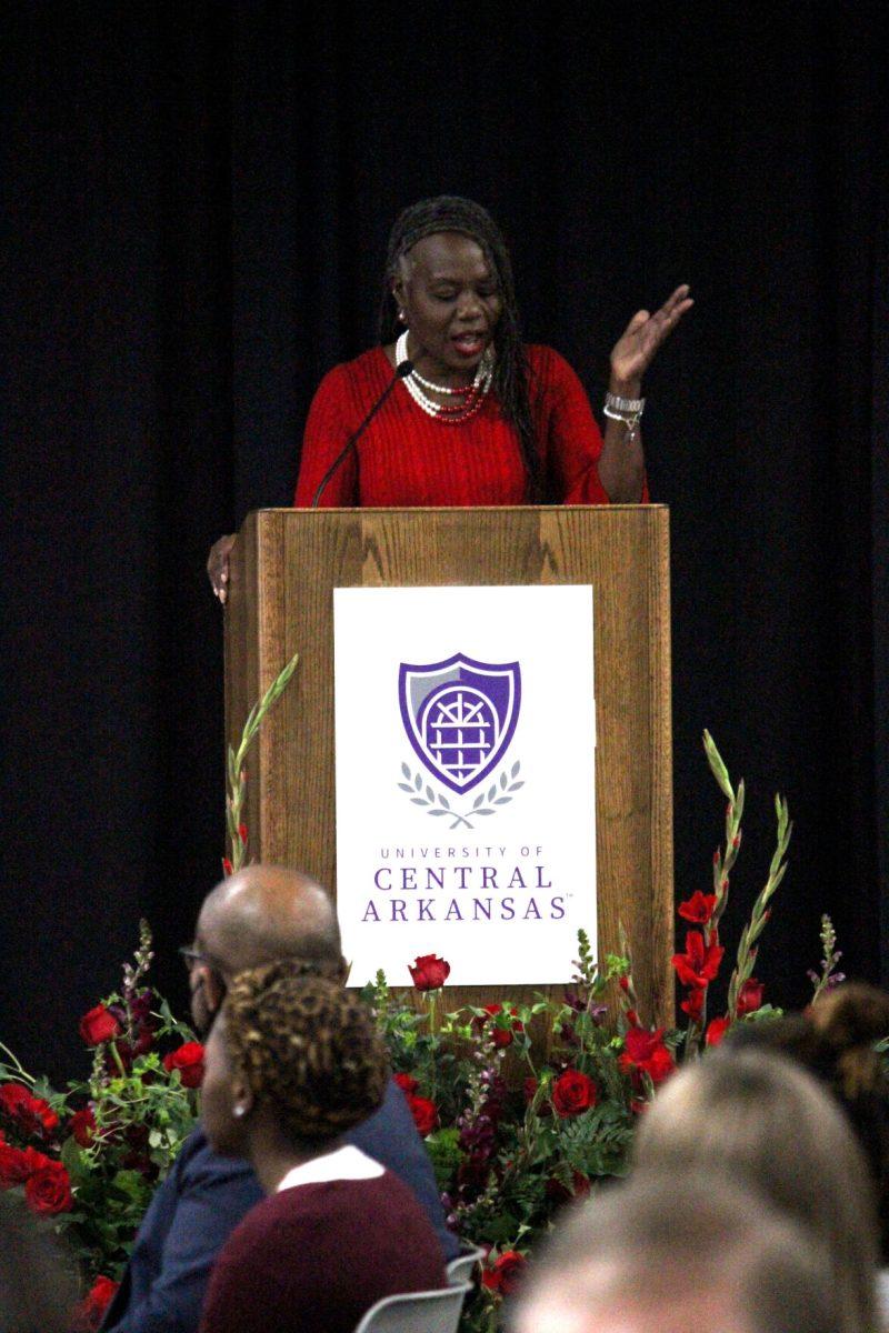 Associate professor of public relations Riva Brown speaks to the Martin Luther King, Jr. Prayer Breakfast crowd about how they could use QR codes at their tables to donate to the Bear Essentials Food Pantry.