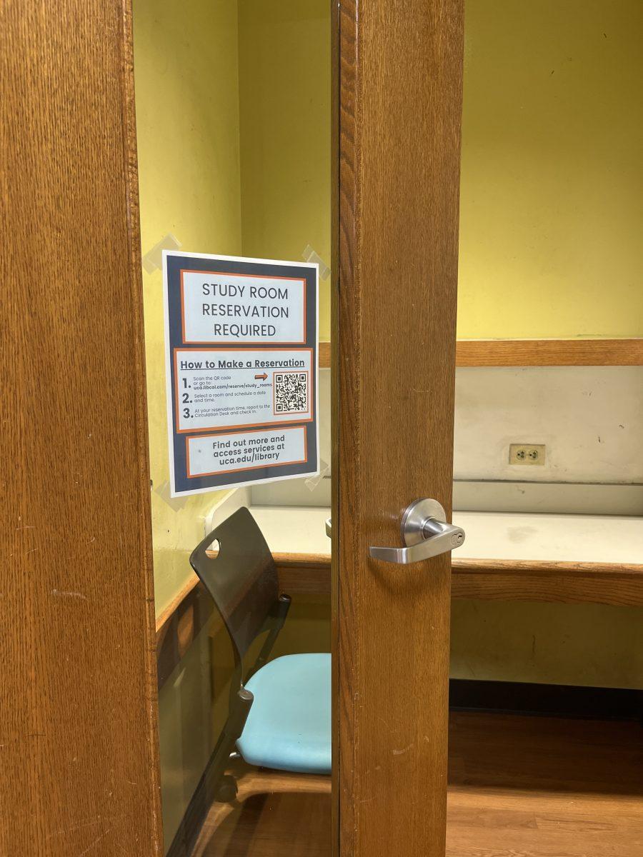 A flyer taped to an individual study room door asks students to make reservations. Group study rooms have been on a reservation basis since fall 2021.