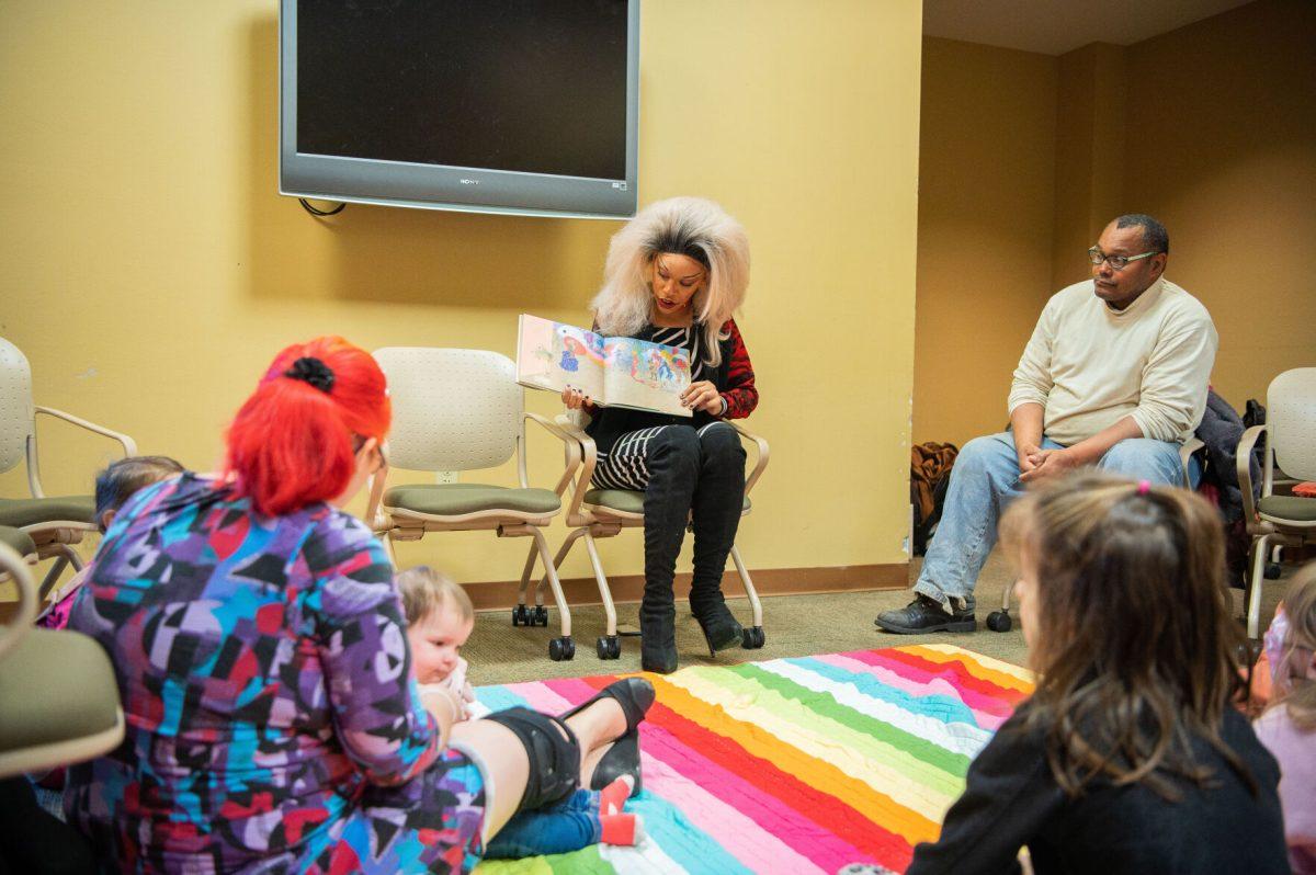 Angila Dubois, an Arkansas drag performer, reads "If You're a Drag Queen and You Know It" by Lil Miss Hot Mess in a Faulkner County Library room. The event took place 10 a.m. Jan. 15 and was organized by the Faulkner County Coalition for Social Justice.