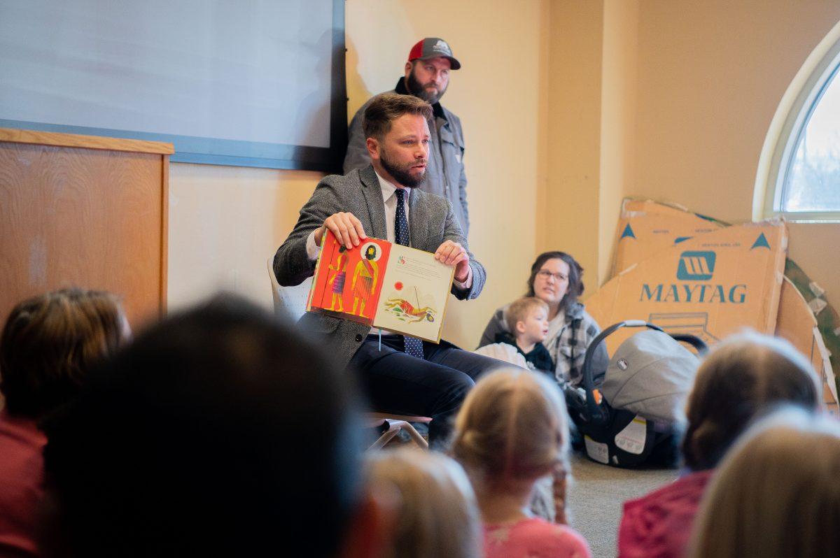 Owen Strachan, a member of Conway’s Grace Bible Theological Seminary, holds up the children's book "God's Design." Strachan himself is an author of books like "Christianity and Wokeness: How the Social Justice Movement Is Hijacking the Gospel - and the Way to Stop It."