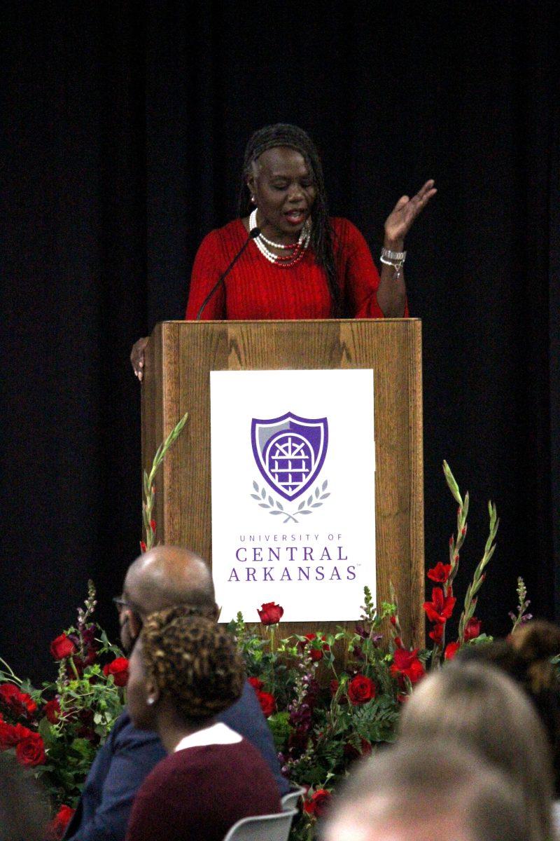 Associate professor of public relations Riva Brown speaks to the Martin Luther King, Jr. Prayer Breakfast crowd about how they could use QR codes at their tables to donate to the Bear Essentials Food Pantry.