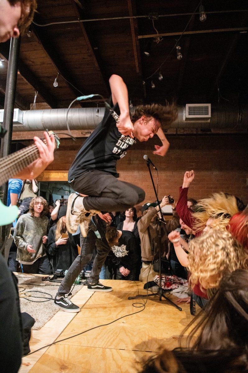 Zashed vocalist Jackson Edwards leaps in the air during the band's performance.
