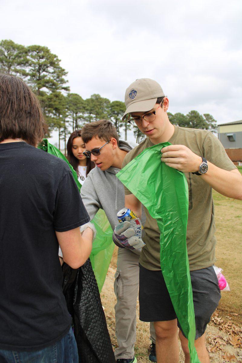 Junior resident assistant Cade Richesin prepares a recycling bag for use. Farris Hall RA's organized the event to foster community involvement and stewardship of the local ecosystem. 