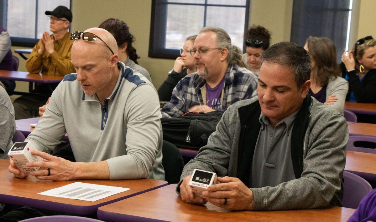 UCAPD Lieutenant Mike Shaw and Patrol Sergeant Kevin Ford look at Naloxbox kits given to them by Stephanie Rose. The training was Feb. 9 and registration for future trainings are full.