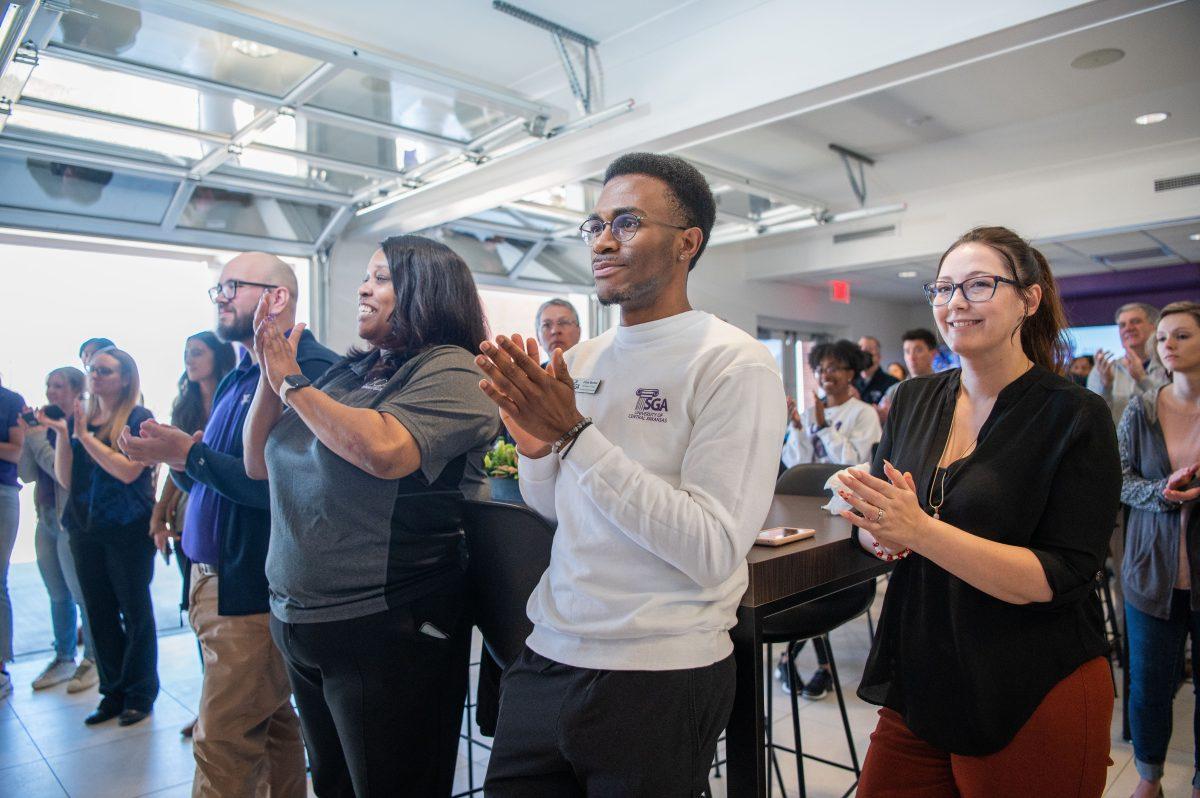 SGA’s Vice President of Finance J’Lun Herron claps alongside UCA staff and faculty during the March 10 announcement of the fundraiser’s totals.