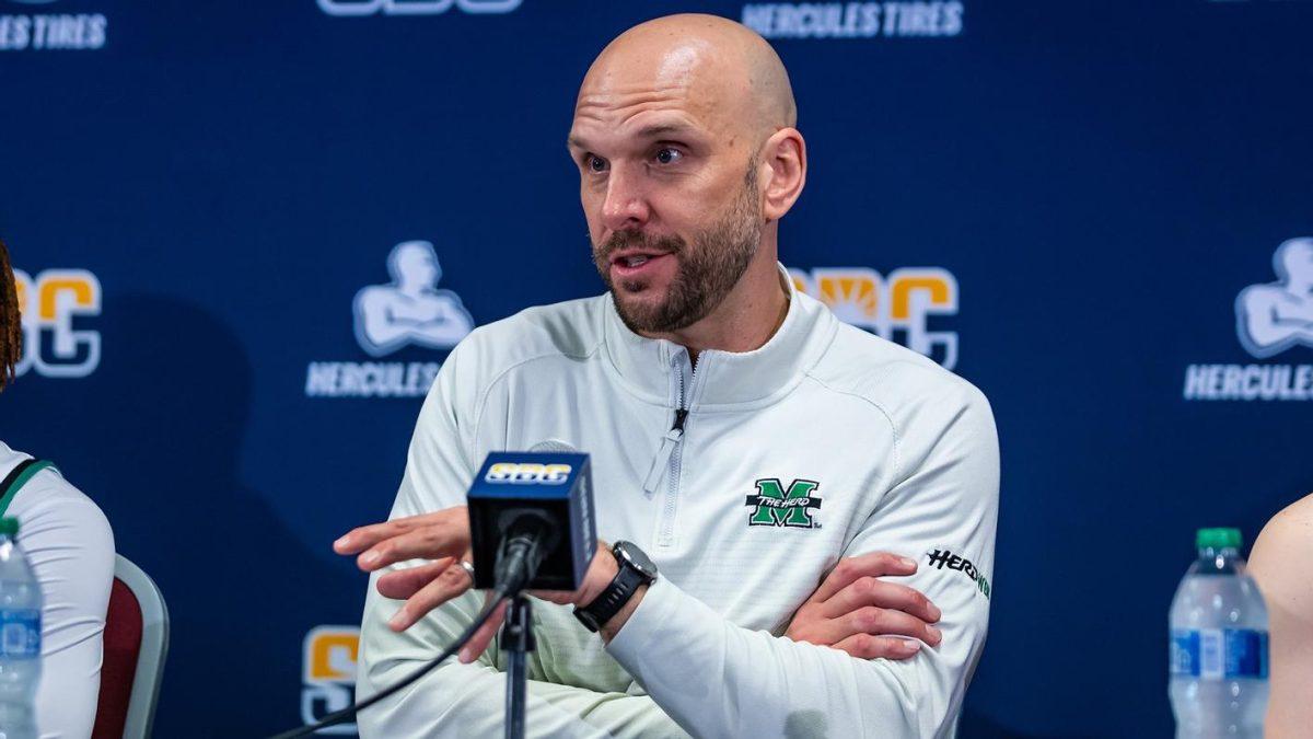 Tony Kemper, previously the coach of Marshall University's women's basketball team, sits in at an ASUN news conference. Kemper ended his final season with Marshall with an overall score of 17-14.