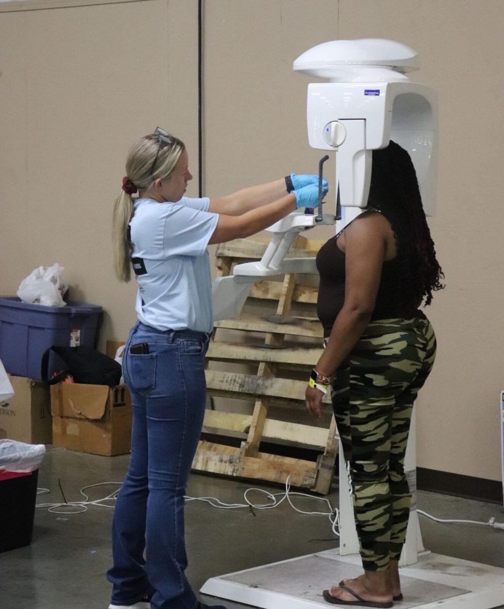 A volunteer X-rays a patient. Along with X-rays, the event provided cleanings, extractions and fillings.