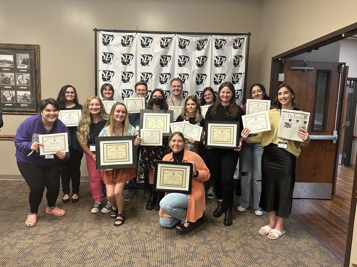 The Echo’s staff hold up awards from the Arkansas College Media Association conference April 14. The paper’s editor-in-chief, Mia Waddell, won reporter of the year.