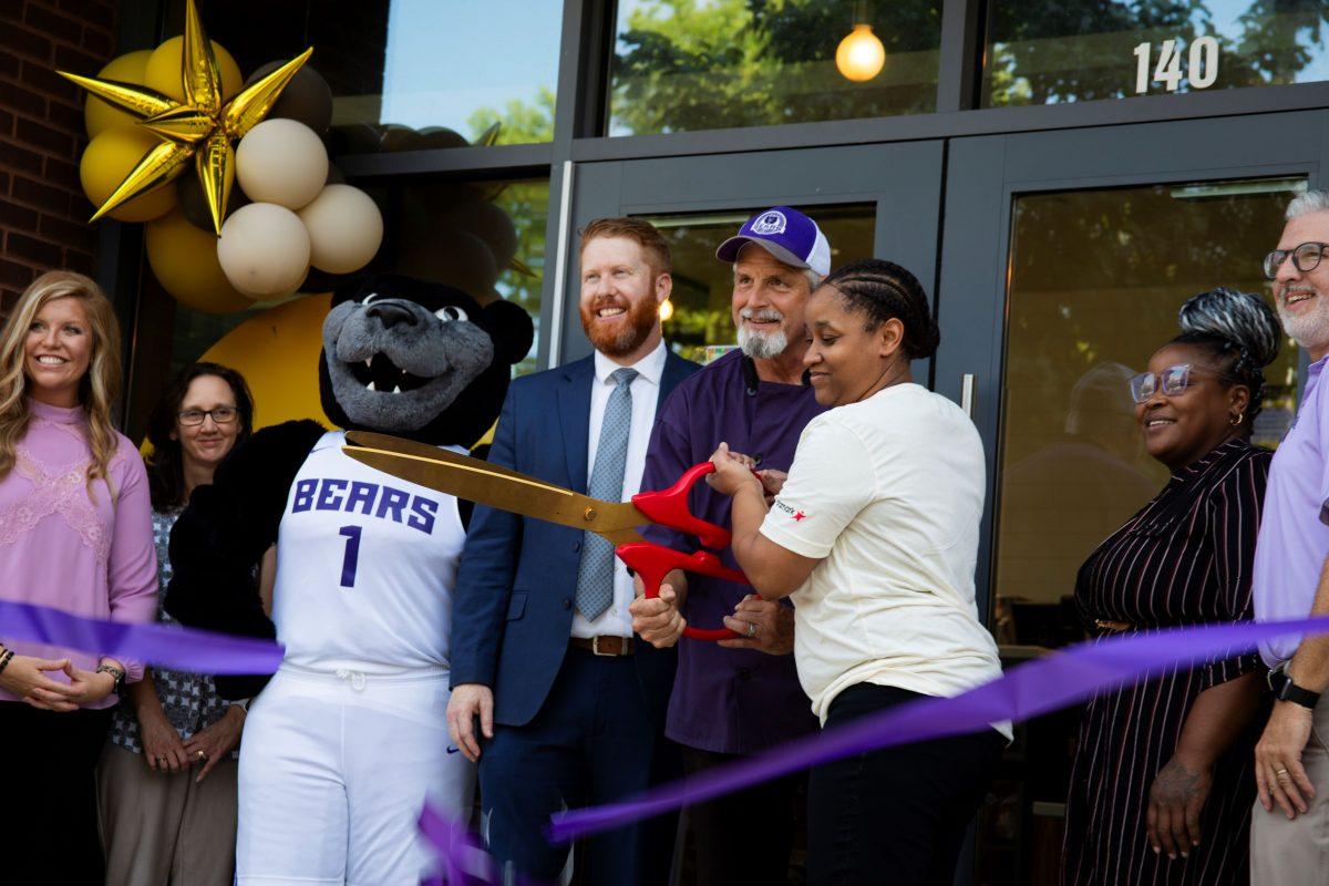 From left: Vice President of Finance and Administration Terri Canino, Bruce D. Bear, Aramark Genera Manager Joshua Gorham and Paul Deden smile for the cameras after cutting the ceremonial ribbon. The official grand reopening of 1907 Bread Co. was Sept. 6.