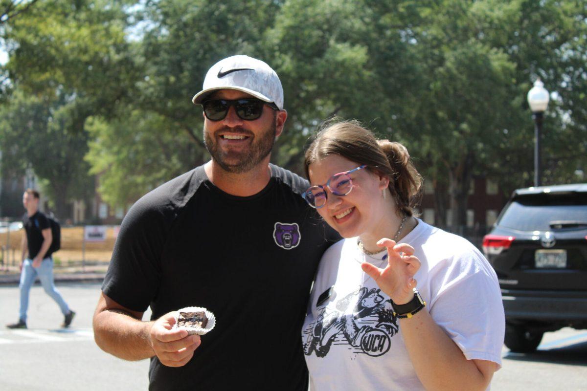 Football coach Nathan Brown poses with Sophomore Kathryn Eggebrecht at Brownies with Brown. The event promoted the first football game of the season. 