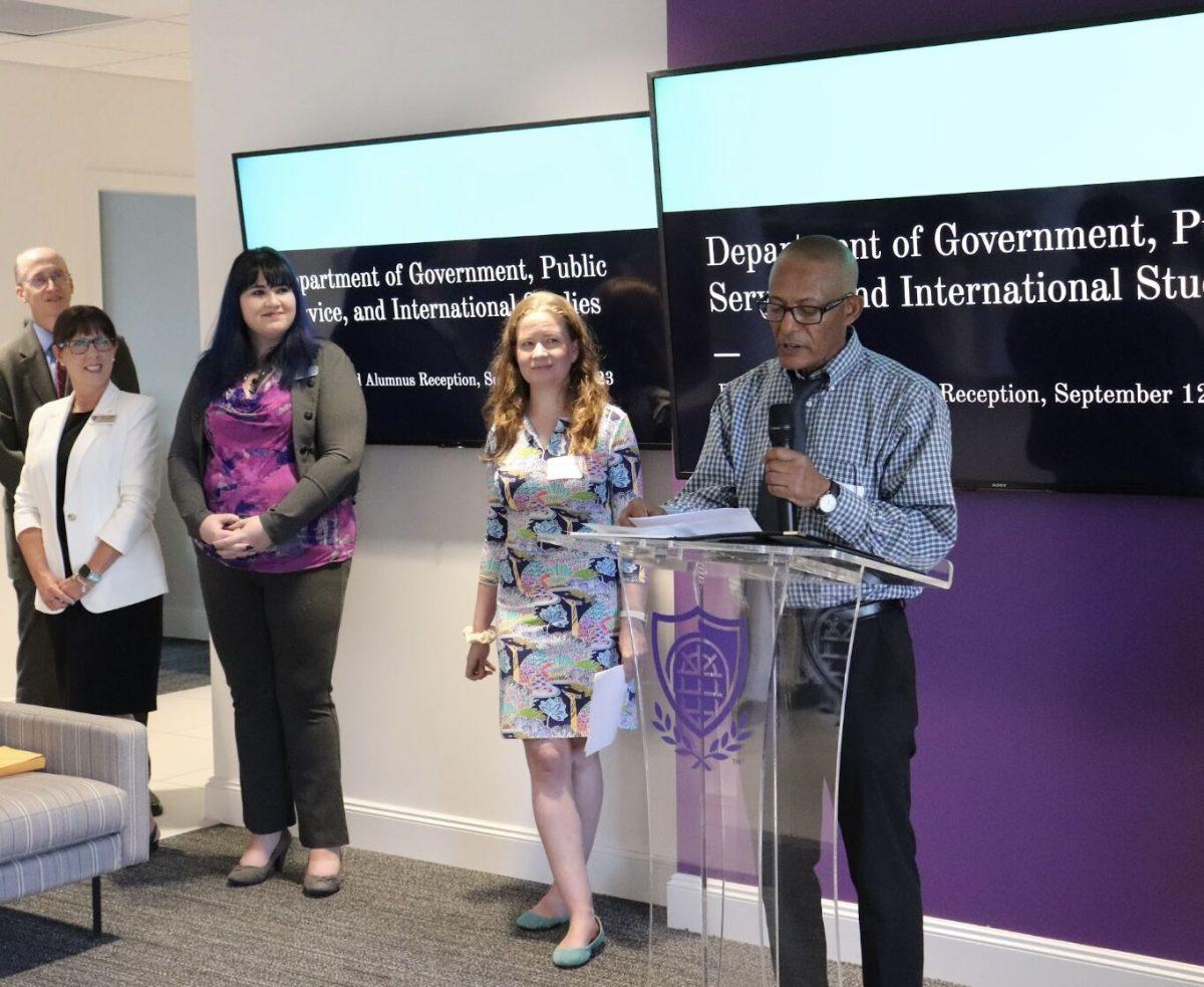 From left, Bailey Fairbanks and Mary Beth Sullivan listen to Gizachew Tiruneh speak Sept. 12. Faculty from the Department of Government, Public Service and International Studies announced two new programs for students.