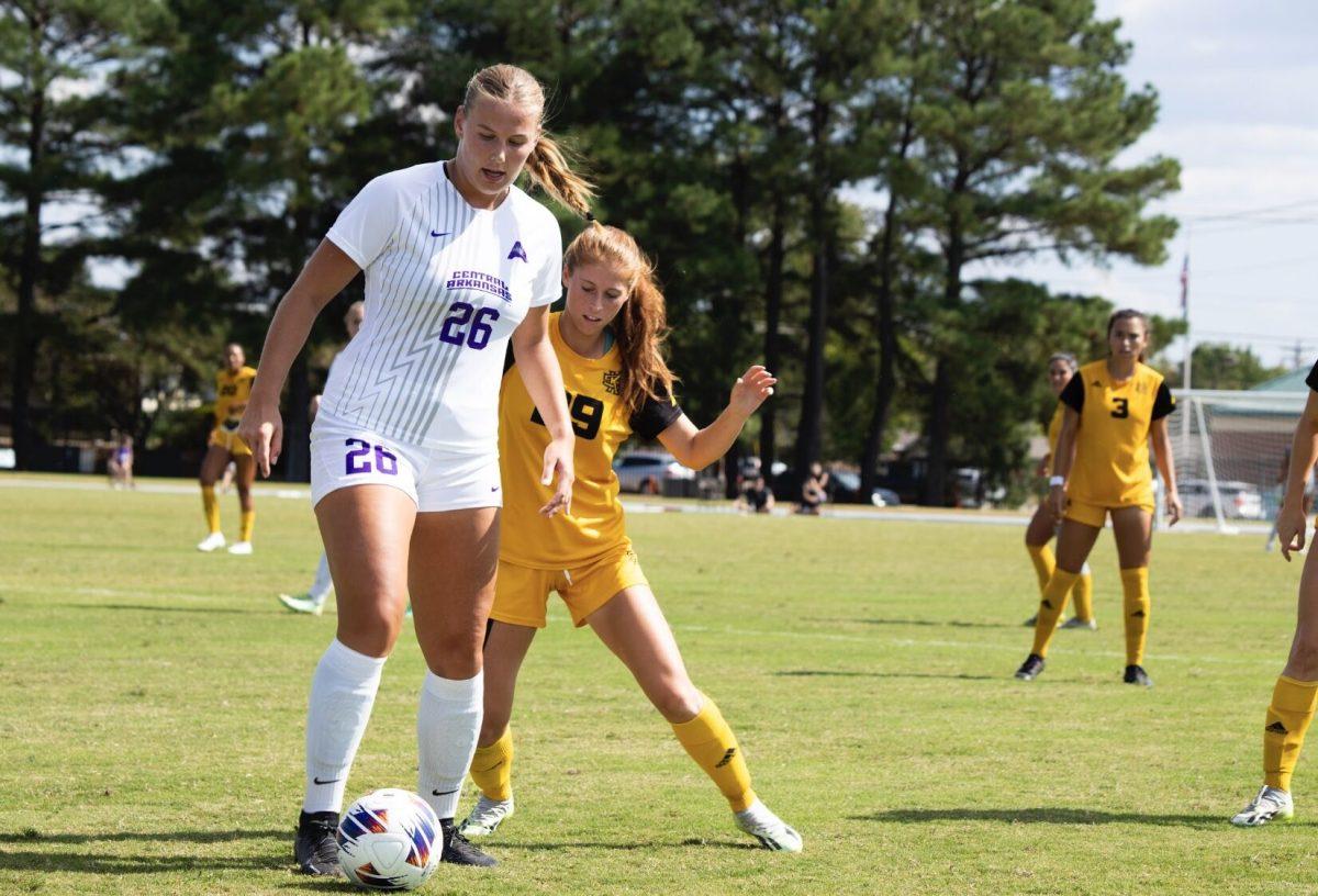 Sophomore forward Lea Duus Madsen protects the ball from the Owl defender. 