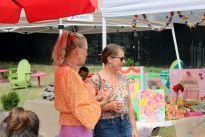 Locals peruse the market and look at artwork. 