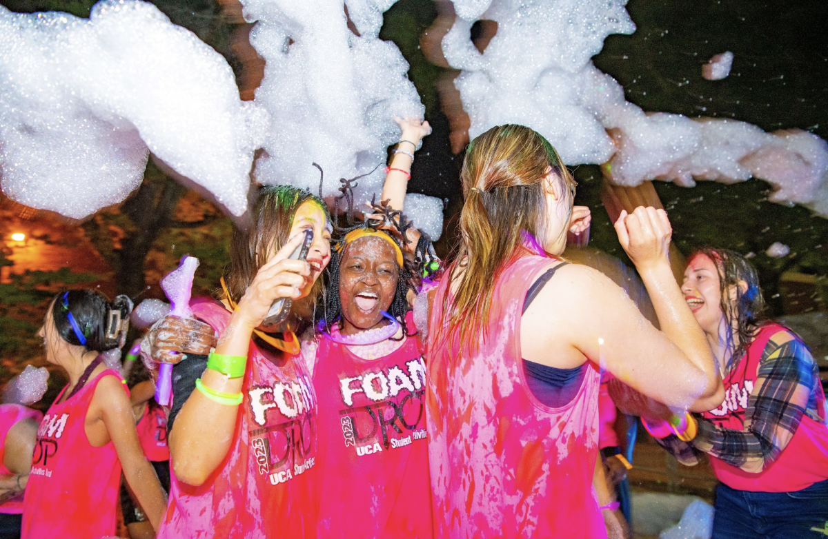 Students jump around to music at the SAB Foam Drop Paint Party. The DJ shot foam into the energetic crowd. 