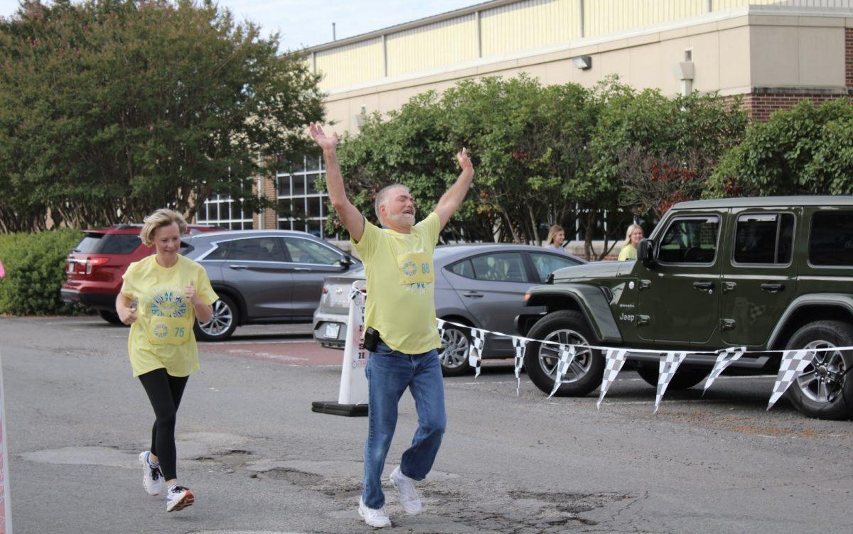 Participants run through the finish line at the Be the Light 5K. The money raised went to the American Foundation for Suicide Prevention.