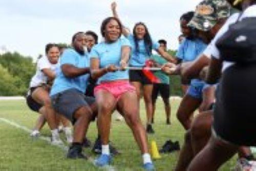 Students participate in a game of tug of war during the Minority Mentorship Program Color Wars event.