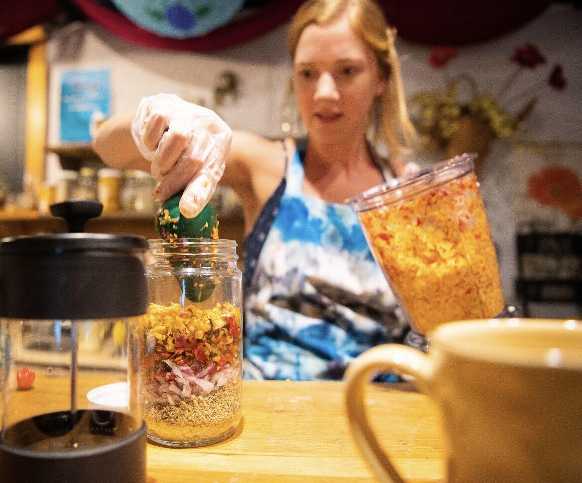 Clark carefully scoops her blended mixture into her mason jar.