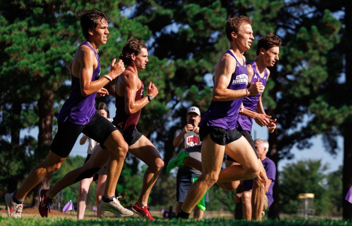 Senior Thomas Caine pushes forward at the Chile Pepper Festival 8K in Fayetteville, Arkansas. The men's cross country team finished 10th out of 30, and the women's team finished 6th out of 36.